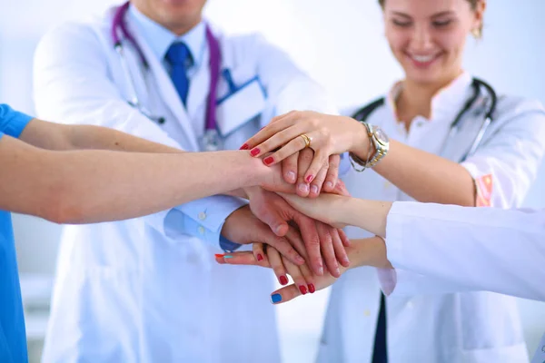 Doctors and nurses in a medical team stacking hands — Stock Photo, Image