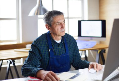 Ofisteki çizim masasında çalışan mimar