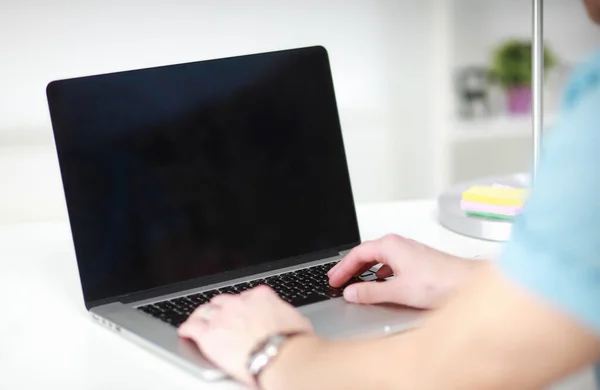 Handsome young man sitting and working on laptop computer — Stock Photo, Image