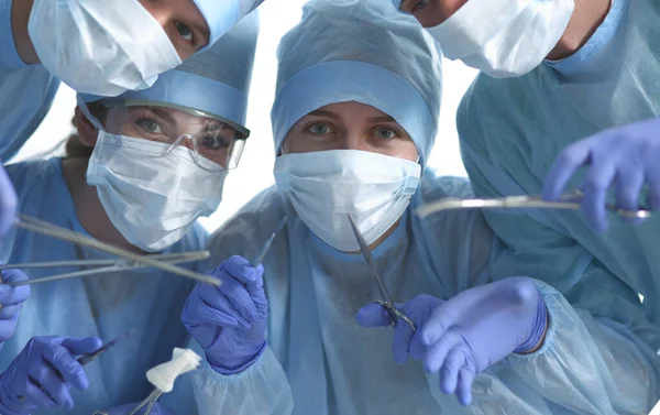 Below view of surgeons holding medical instruments in hands — Stock Photo, Image