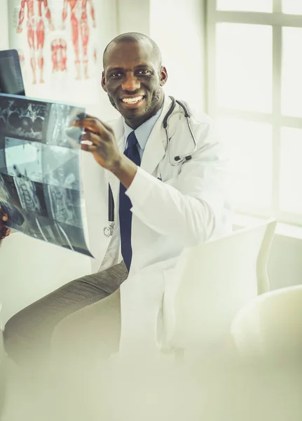 Portrait young african medical doctor holding patients x-ray — Stock Photo, Image