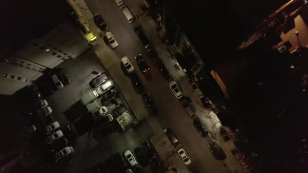 AERIAL: Dark parking Lot Overhead Top-down Bird View at Night in Chinatown, Manhattan, New York City with Car Exiting — 图库视频影像