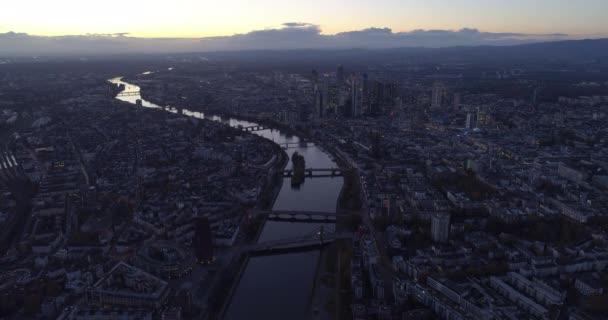 AERIAL: Establishing Shot above all of Frankfurt am Main, Germany Skyline high in the Air at Dusk Sunset light with European Central Bank and Downtown Lights — стоковое видео