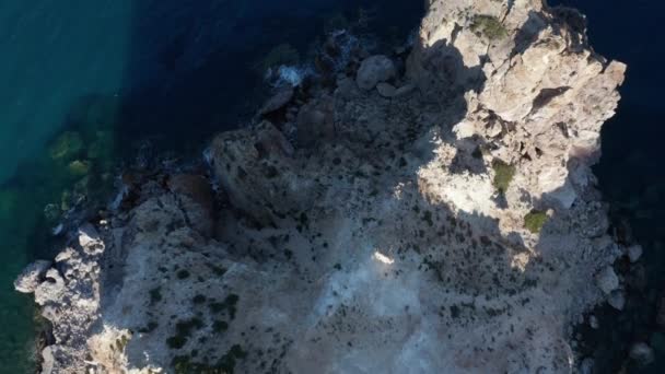 Overhead Top Down Aerial of Generic Mountain Coast with Turquoise Water and Waves Crash on Rocks on Greek Island at Sunset — Video