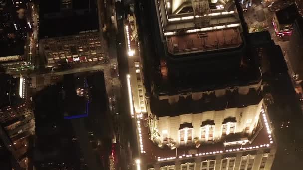 AERIAL: Häpnadsväckande cirkel över den ikoniska Empire State Building ovan lyste upp parallella avenyer och korsningar bostäder lägenheter och kontorsbyggnader i Midtown Manhattan, New York City på natten — Stockvideo