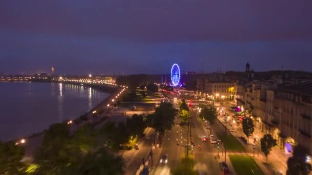 Night Hyperlapse of Bordeaux, France Riverside with Ferriswheel, Aerial forward — стокове відео