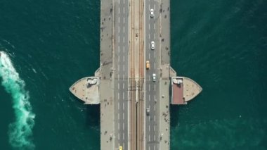 Galata Köprüsü 'nün tam üstünde küçük araba trafiği ve oradan geçen martı kuşları, Yavaş Havadan Kuşların Gözü Tepeden Aşağı Görünümü