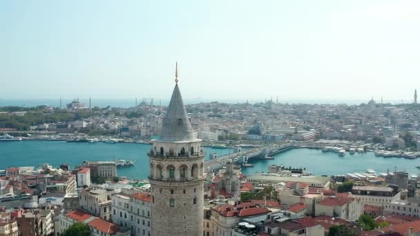 Langs Galata Tower onthult Galata brug over Bosporus met prachtige heldere blauwe lucht, langzame antenne voorwaarts — Stockvideo
