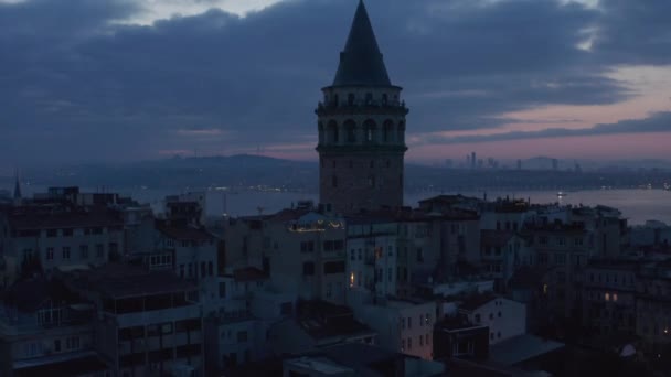Створення Shot of Galata Tower у Dark Blue Hour з Bosphorus у Background та Red Purple Sky, Aerial Crane Up розкриває — стокове відео