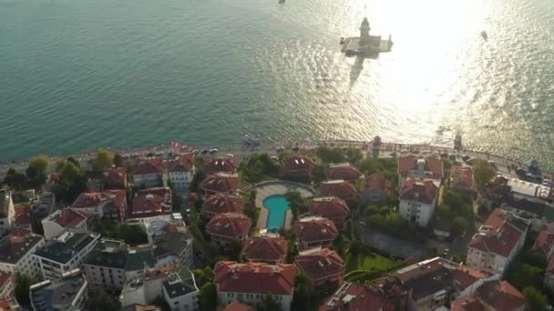 Hotel Resort on Bosphorus Riverside with view on Maidens Tower in beautiful Afternoon light, Slow forward Aerial tilt down — Stock Video