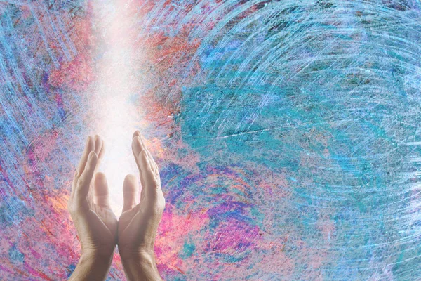 Channeling Quantum Healing Energy to Calm the Turbulent Atmosphere - Male parallel hands facing upwards with a beam of bright white energy flowing up on a chaotic pink and blue background