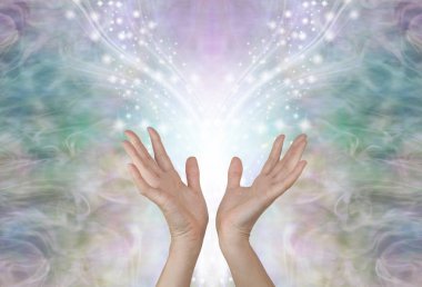 Energy flows where your attention goes - female hands reaching up towards a symmetrical shower of glittering sparkles against an ethereal pale green gold energy background                              clipart