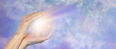 Sending Beautiful Healing Light across distance  - female hands cupped around a bright burst of light against a celestial cosmic sky  background with copy space  clipart