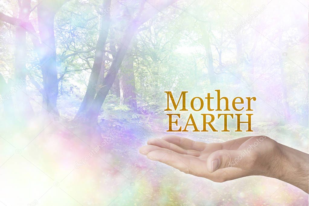 Be kind and loving towards Mother Earth - male open palm with the words MOTHER EARTH floating above on a rainbow coloured tree landscape bokeh background with copy space