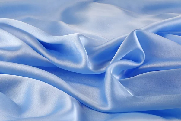 Cascading Folded Blue Silk Background - folds of beautiful high quality luxurious sky blue silk ideal as a background