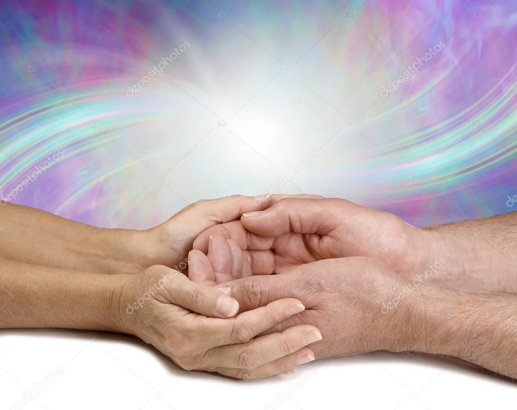 Sharing my Energy with You - female hands cupped lovingly around male cupped hands against a flowing energy formation background with copy space