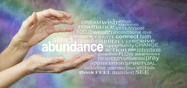 Attract Abundance Word Tag Cloud - female hands with the word ABUNDANCE floating between surrounded by a relevant word cloud on a rainbow coloured  rustic grunge background