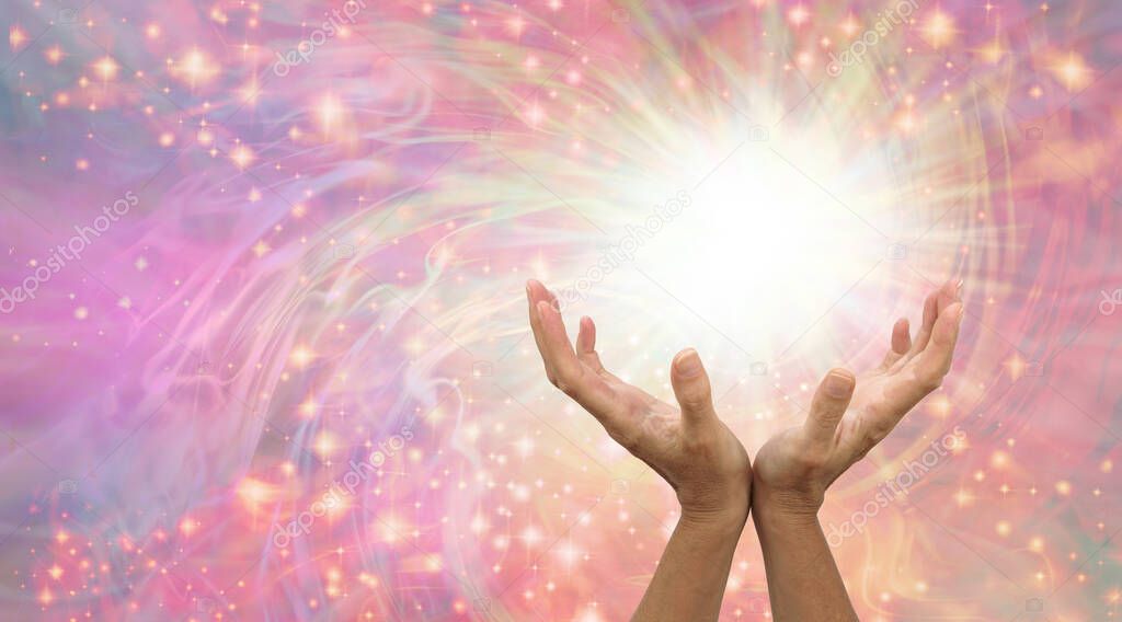 Healing is a magical experience  - female hands with with white light and a flow of sparkles against a pale rainbow coloured background with room for messages