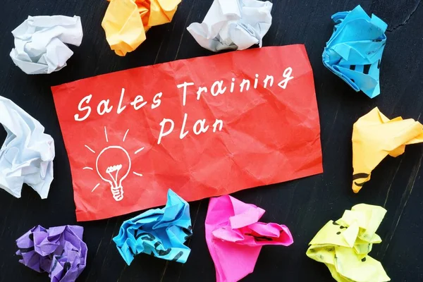 Sales Training Plan inscription on the piece of paper.