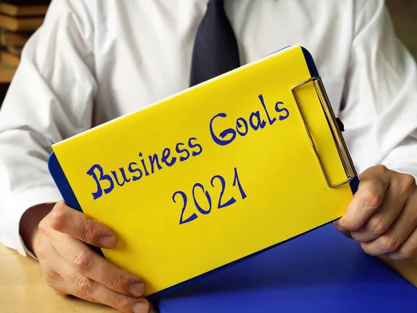Business concept about Business Goals 2021 with phrase on the piece of paper.