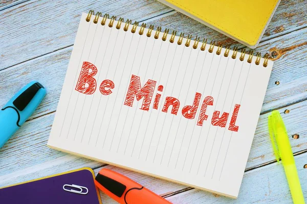 Business concept about Be Mindful with sign on the piece of paper.