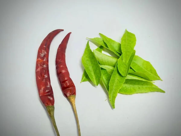red chilli, curry leaf On A White Background Stock.this photo is taken in india by vishal singh