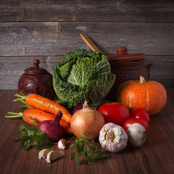 木製の背景に木製のテーブルの上に横たわる野菜のある静物 — ストック写真