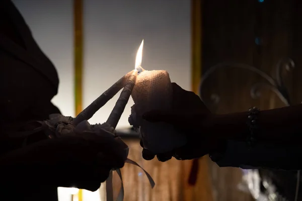 Hands hold candles, light a candle, family fire silhouette