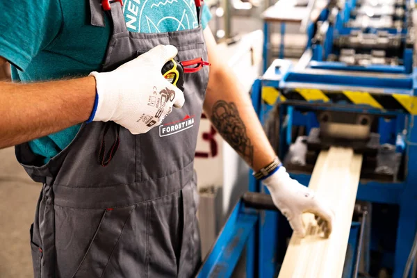 Worker at factory measures works metal production industrial