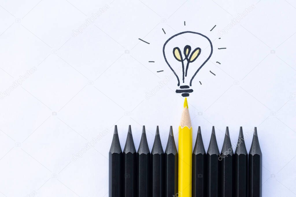 one yellow pencil with a light bulb among black ones. business concept