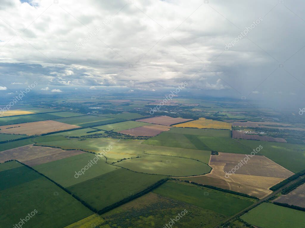 Aerial drone view. Rain clouds over the Ukrainian field. It is raining.