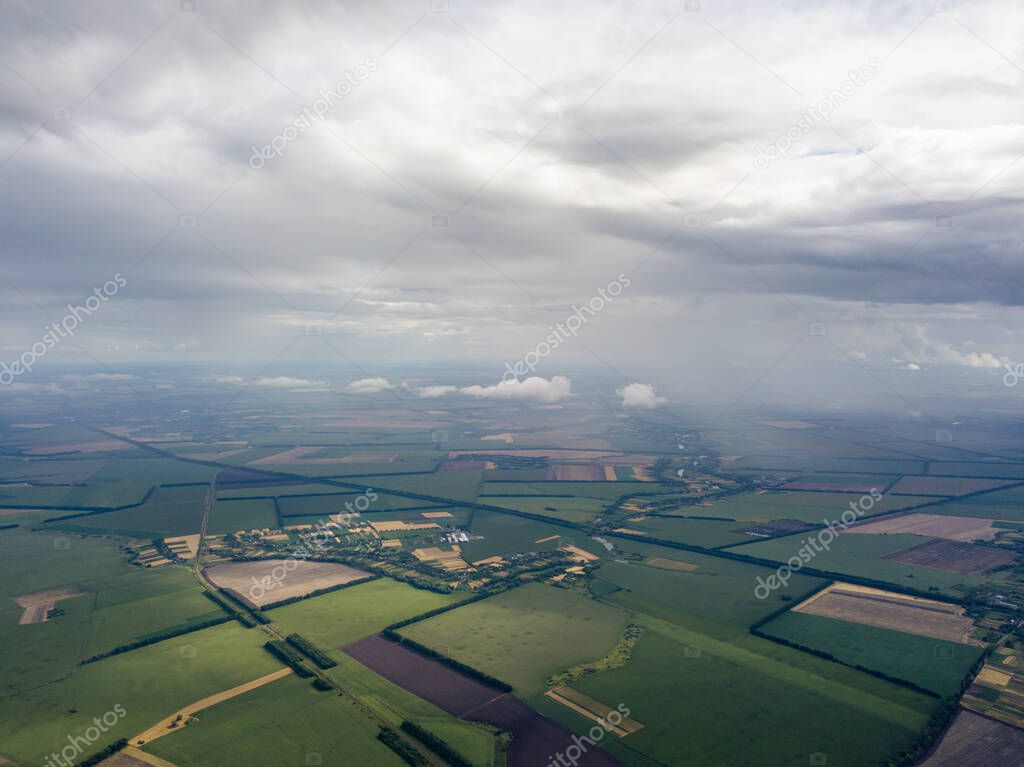 Aerial drone view. Rain clouds over the Ukrainian field. It is raining.