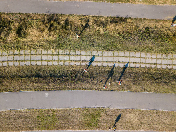 Aerial drone view. Mowing grass on the side of the road with petrol trimmers.