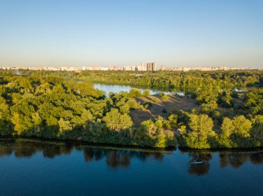 Güneşli bir yaz gününde Dinyeper nehrinin yeşil kıyısında. Hava aracı görünümü.