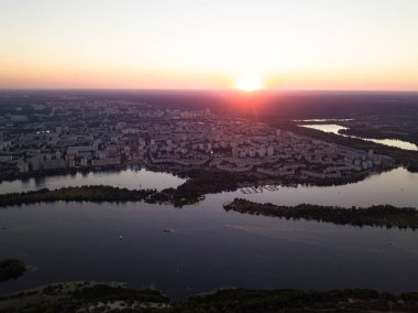 Hava aracı görüntüsü. Dinyeper Nehri ve Kiev şehrinin üzerinde gün batımı.