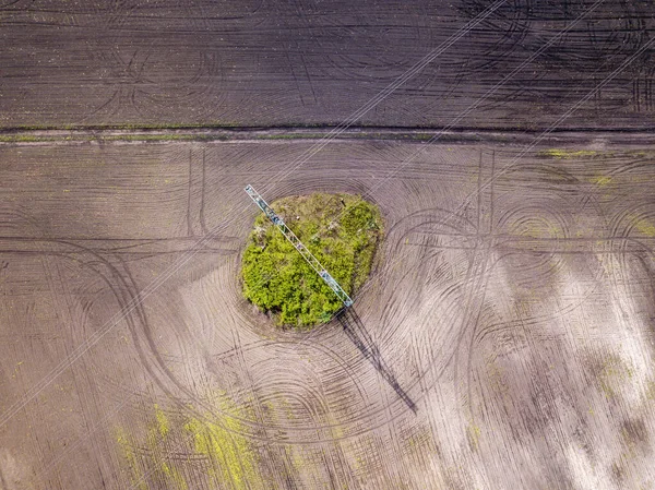 空中ドローンビュー 耕された畑の間の送電線のポスト 春の晴れた日 — ストック写真