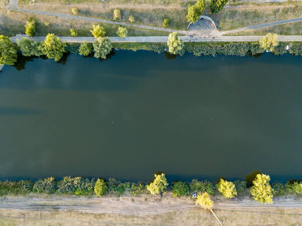 Aerial drone view. Walking paths near the lake in the city park of Kiev.