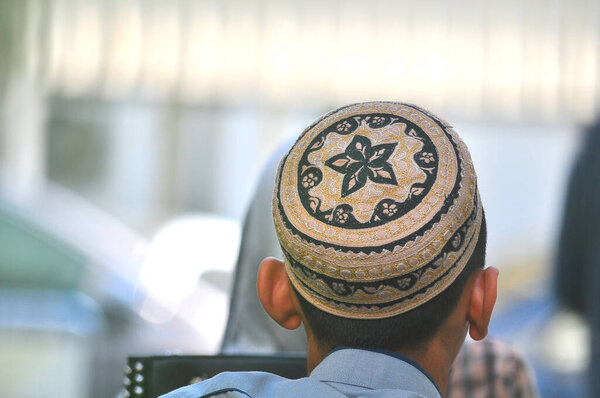 Muslim young boys wear a beauty Muslim prayer cap during travel in Chiang Mai of Thailand