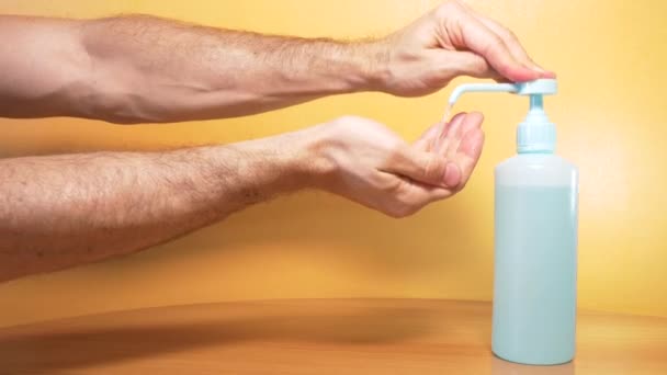 Men Hands Applying Antibacterial Liquid Orange Background — Stock Video