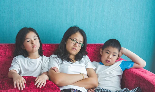 bored family fell a sitting on sofa at home