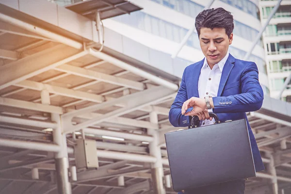 Genç işadamı saatini zamanında kontrol.