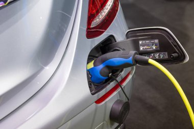 Elektrikli araba aküsünü şarj ediyorum.