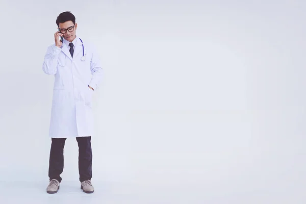 Young Doctor Man Wearing White Coat Using Smartphone — Stock Photo, Image