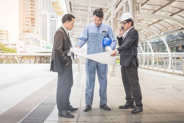 business manager and engineer meeting project at construction site