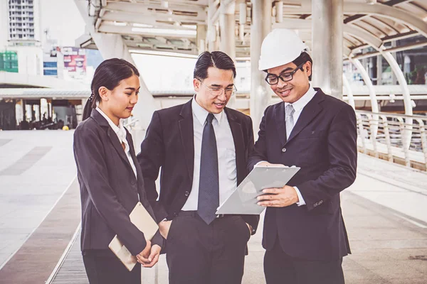 business manager and engineer meeting project at construction site