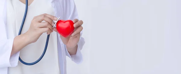 Médico Con Estetoscopio Examinando Corazón Rojo — Foto de Stock