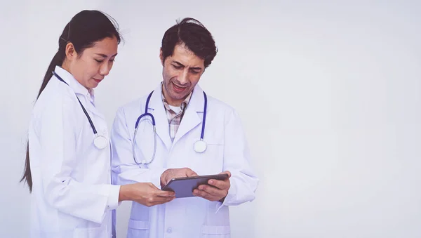 doctors checking patient information on a tablet device, concept teamwork