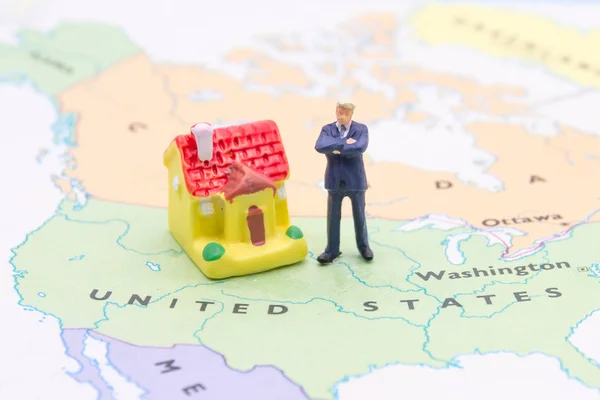 Businessman and house on map American. Miniature people