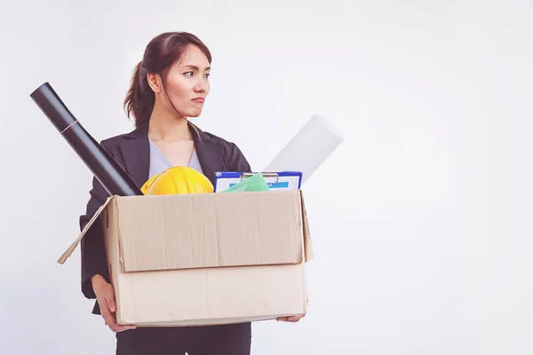 Businesswoman holding box leaving office after quitting job — Stock Photo, Image