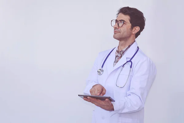 Doctor checking patient information on a tablet device — Stock Photo, Image